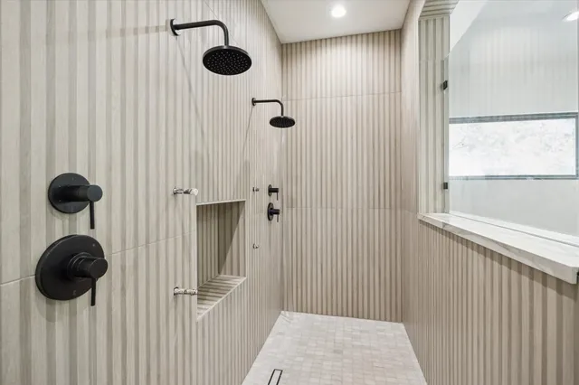 a bathroom with a granite countertop shower