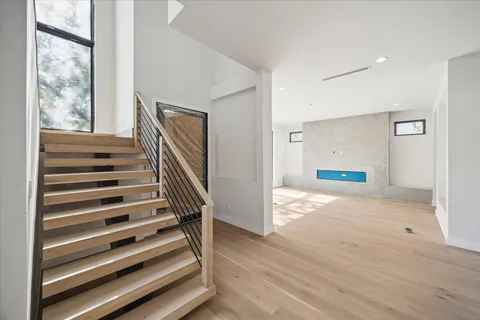 a view of entryway and hall with wooden floor