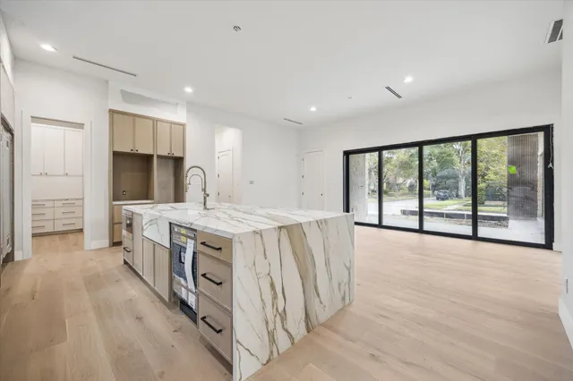a kitchen with a stove and a large window
