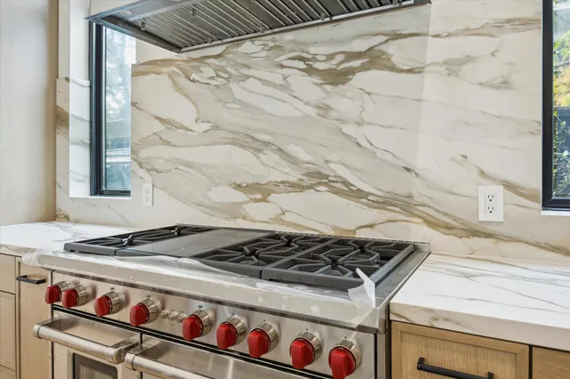 a close view of a stove top oven sitting next to a window