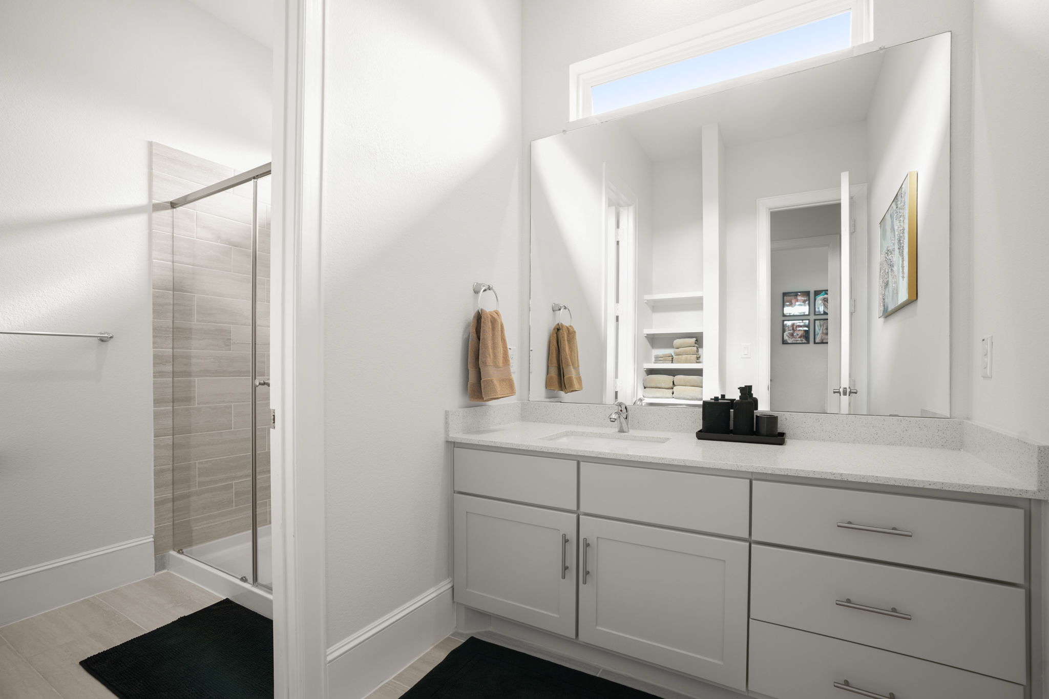 104 Lodestone Cove Austin, TX 78738 - Photo 30 of 40 A well-appointed bathroom features a modern vanity with ample counter space and a sleek glass-enclosed shower.