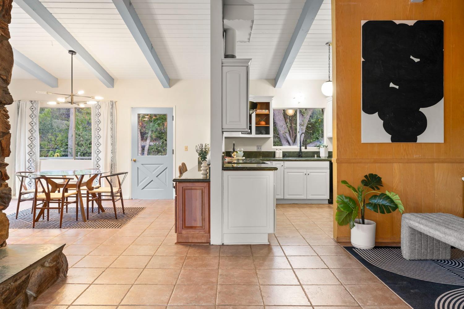 4306 Hendrickson Road Ojai, CA 93023 - Photo 19 of 44 a kitchen with a sink a counter and chairs