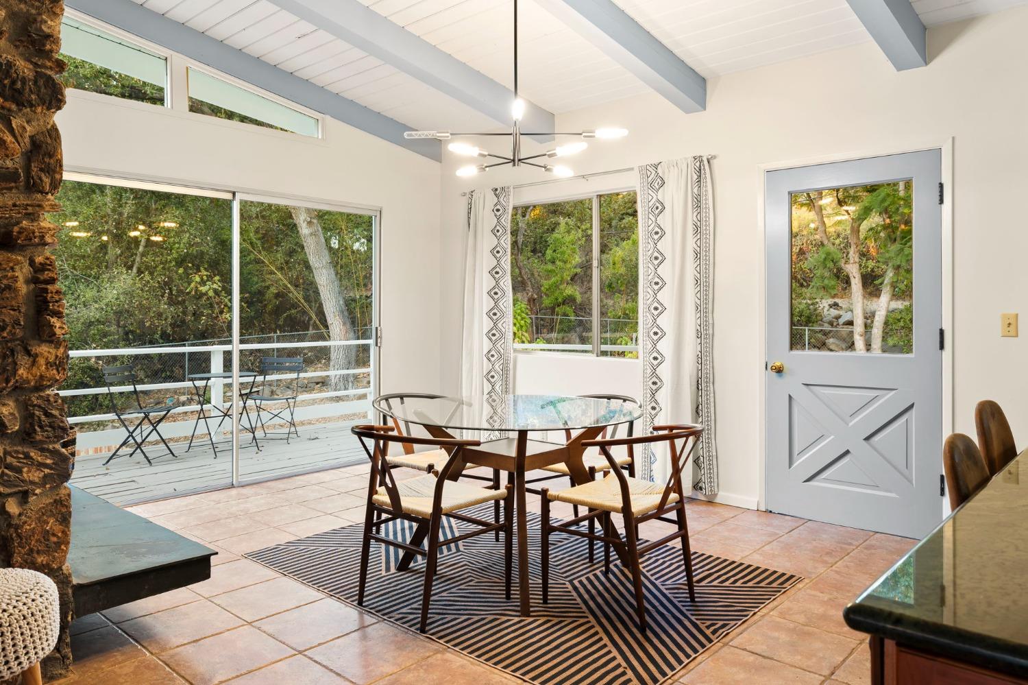 4306 Hendrickson Road Ojai, CA 93023 - Photo 20 of 44 a dining room with furniture a chandelier and wooden floor