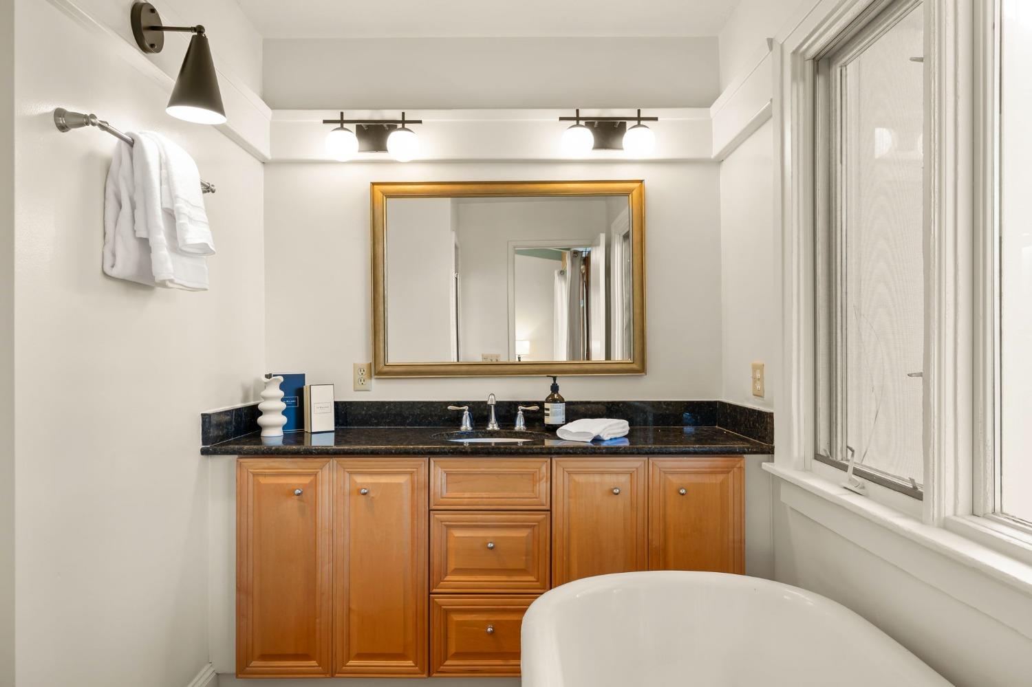 4306 Hendrickson Road Ojai, CA 93023 - Photo 28 of 44 a bathroom with a granite countertop sink and a mirror