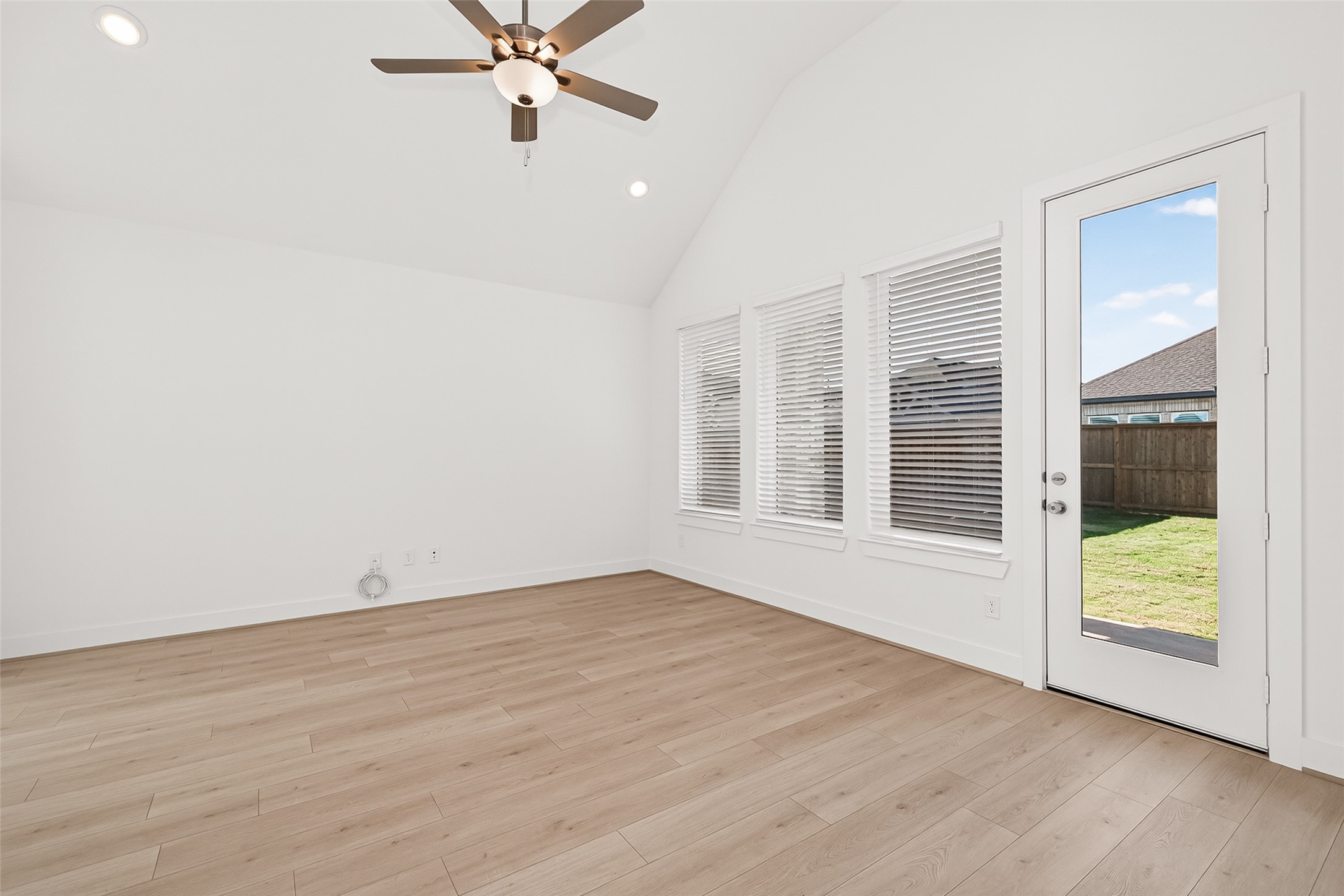 4916 Northern Wds Drive Spring, TX 77386 - Photo 12 of 44 an empty room with wooden floor and windows