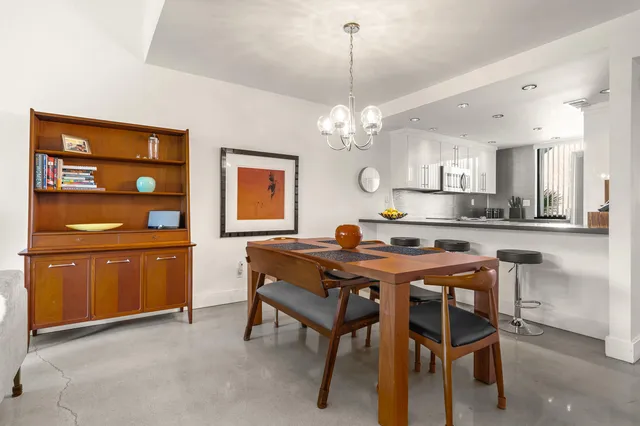 a kitchen with stainless steel appliances granite countertop a sink and a wooden floor