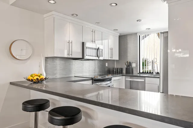 a kitchen with stainless steel appliances a refrigerator and a sink