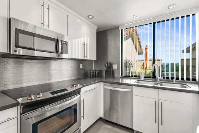 a bedroom with a bed furniture and a large window