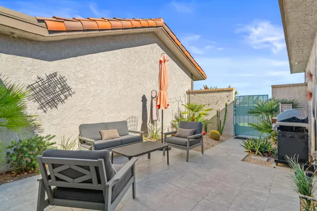 a backyard of a house with table and chairs