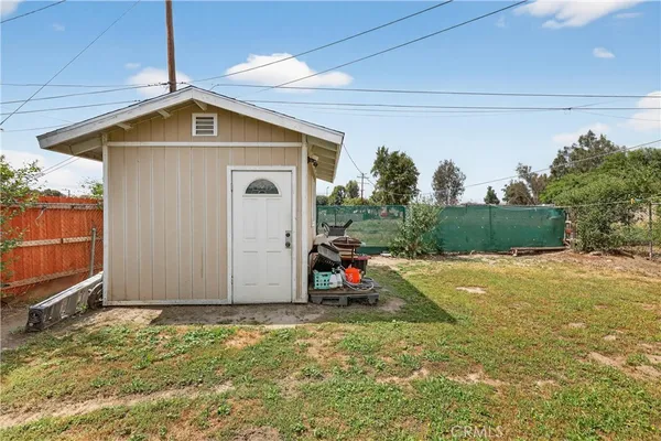 a view of a wooden house with a yard