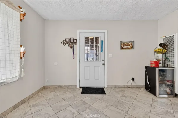 a view of a hallway with wooden floor and windows