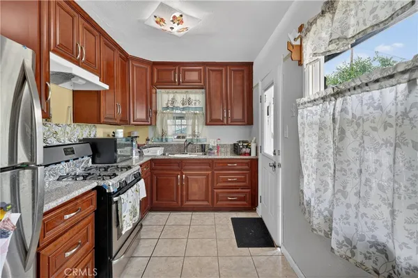 a kitchen with stainless steel appliances a refrigerator sink and cabinets