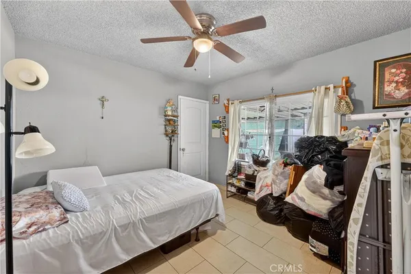 a bedroom with a bed and a large window