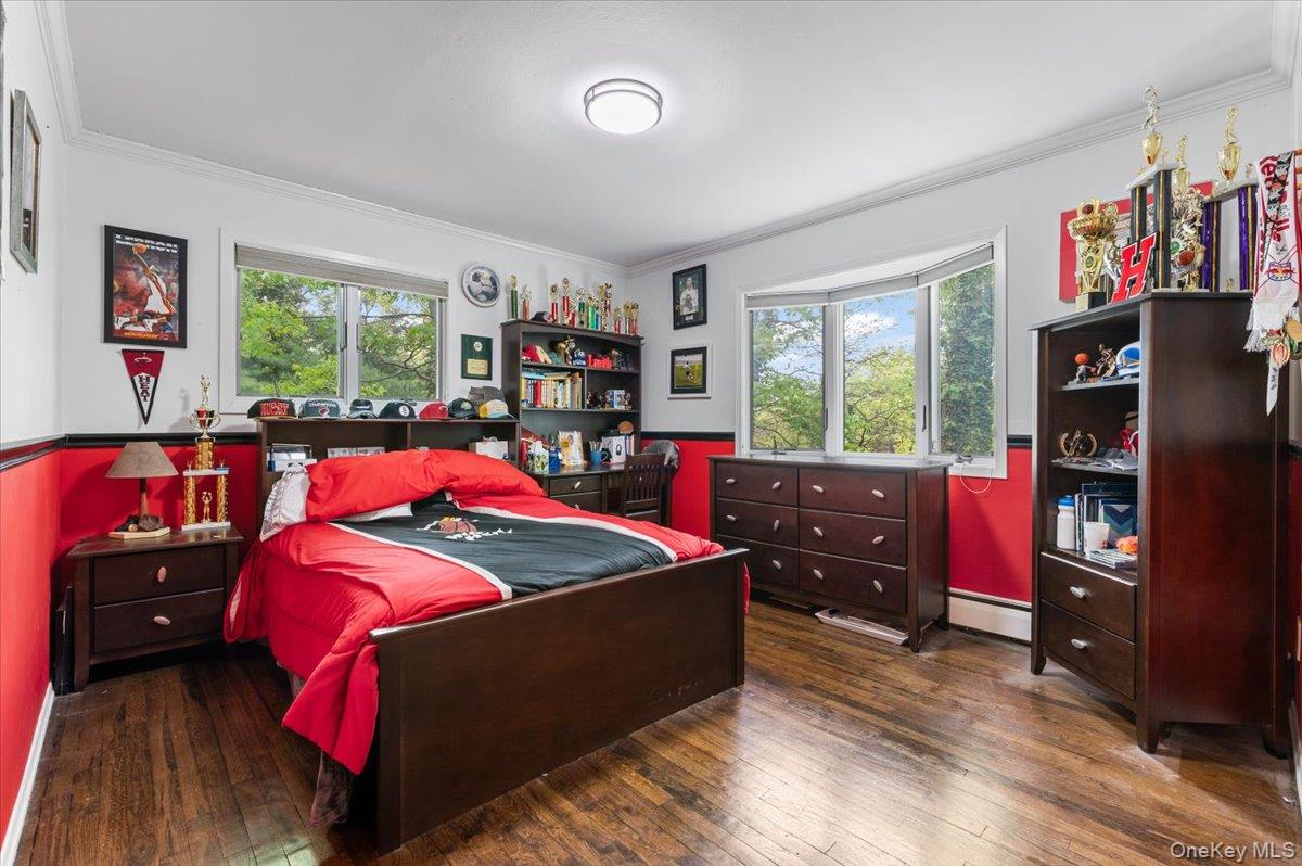 6 Apex Road Melville, NY 11747 - Photo 19 of 50 a bedroom with a bed and a bookshelf
