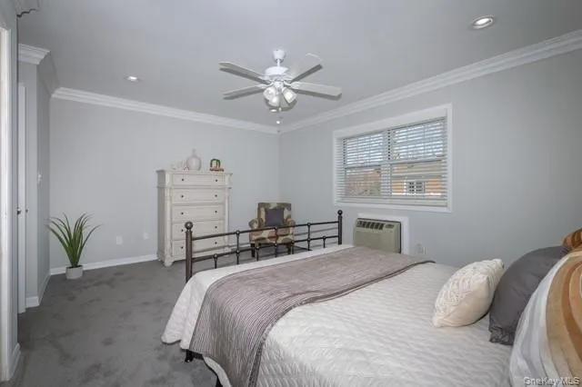 a bedroom with a bed and ceiling fan