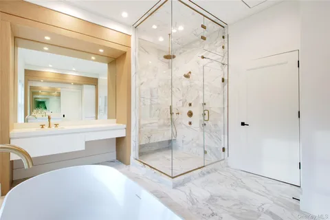 a bathroom with a shower tub mirror and a sink