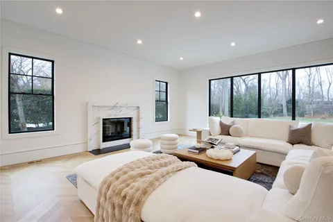 a living room with furniture large window and a fireplace