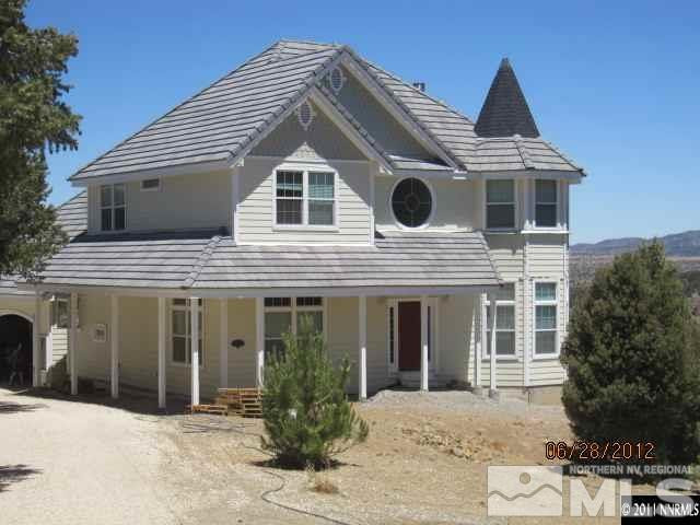 21550 Stallion Road Reno, NV 89521 - Photo 1 of 1 a front view of a house with a yard