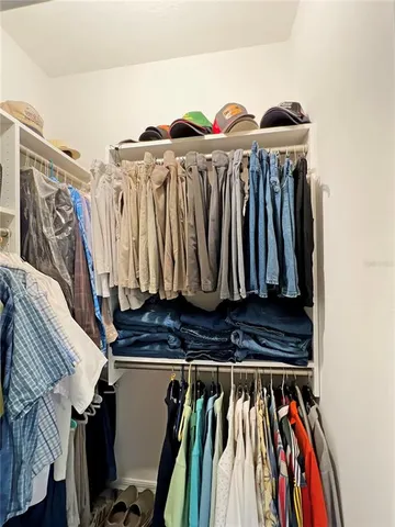 a view of walk in closet with clothes