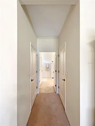 a view of a hallway with wooden shelves