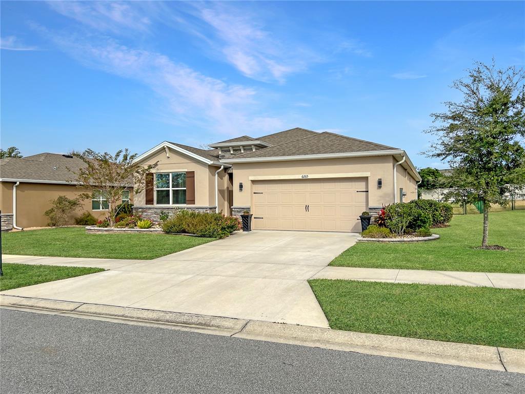 6265 Southwest 88th Loop Ocala, FL 34476 - Photo 21 of 42 a front view of a house with a yard