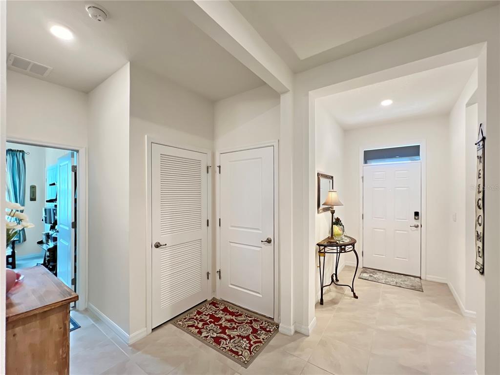 6265 Southwest 88th Loop Ocala, FL 34476 - Photo 29 of 42 a view of a hallway with wooden floor and a bathroom