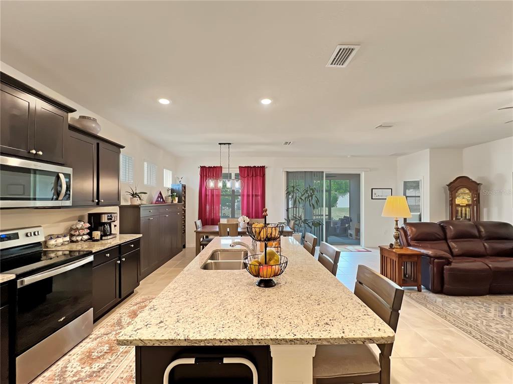 6265 Southwest 88th Loop Ocala, FL 34476 - Photo 3 of 42 a living room with furniture and a flat screen tv