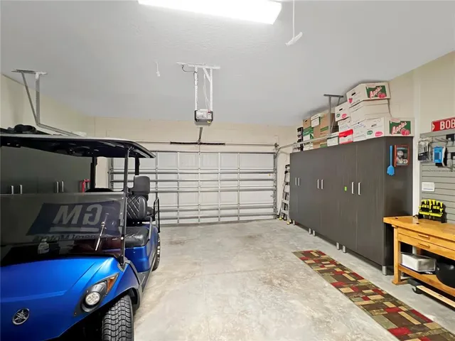 a bedroom with a bed and a flat tv screen on the dresser