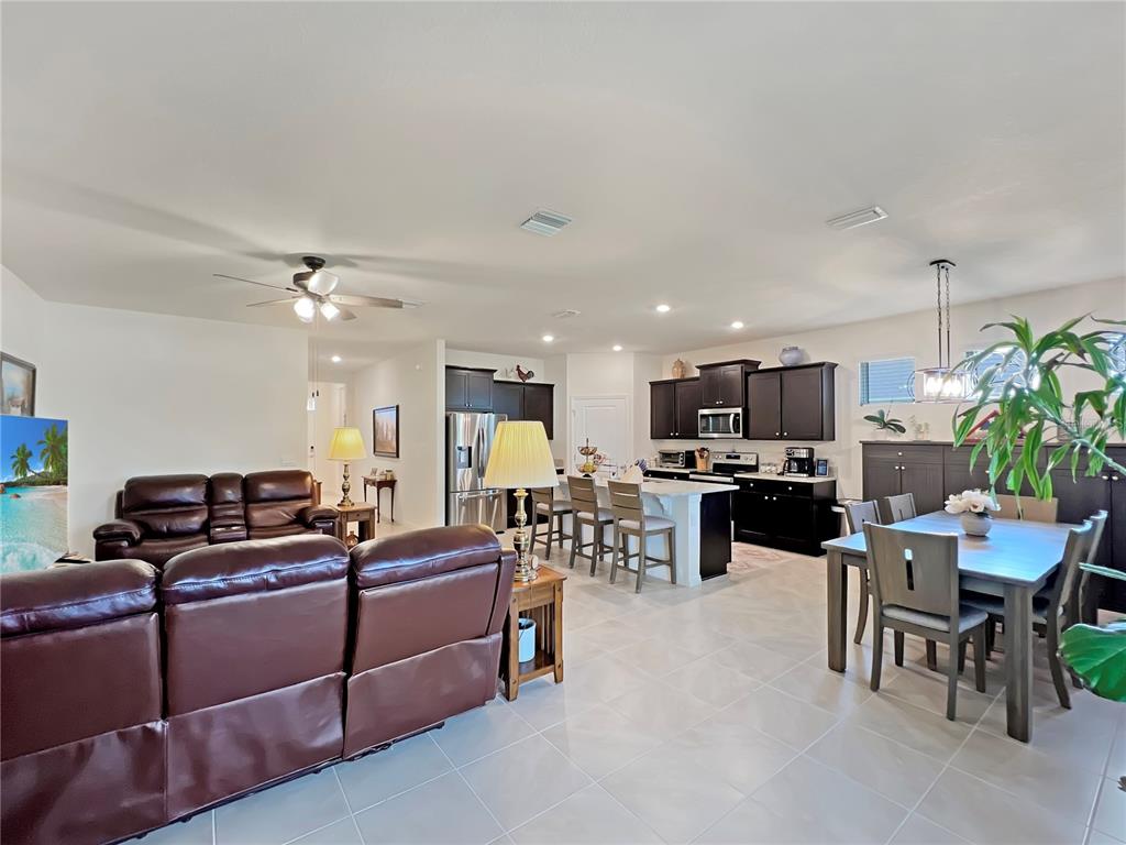 6265 Southwest 88th Loop Ocala, FL 34476 - Photo 4 of 42 a living room with furniture kitchen view and a potted plant
