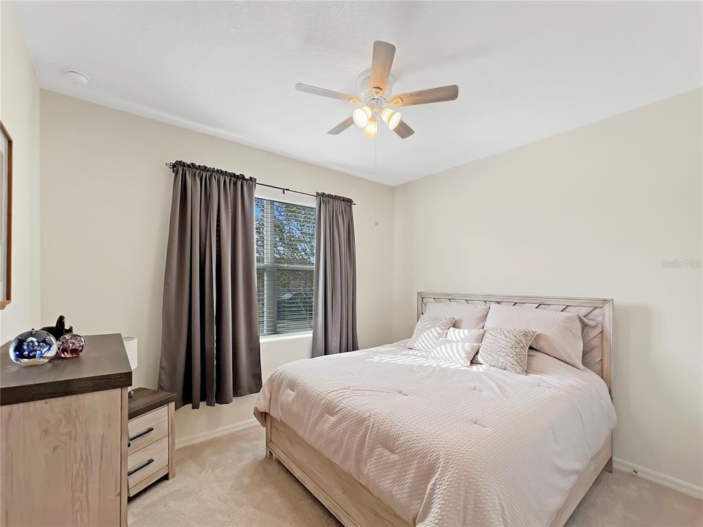 6265 Southwest 88th Loop Ocala, FL 34476 - Photo 7 of 42 a bedroom with a bed and a chandelier