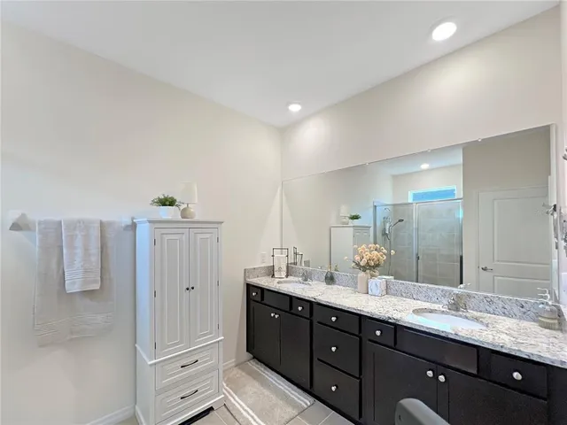 a bathroom with a double vanity sink and mirror