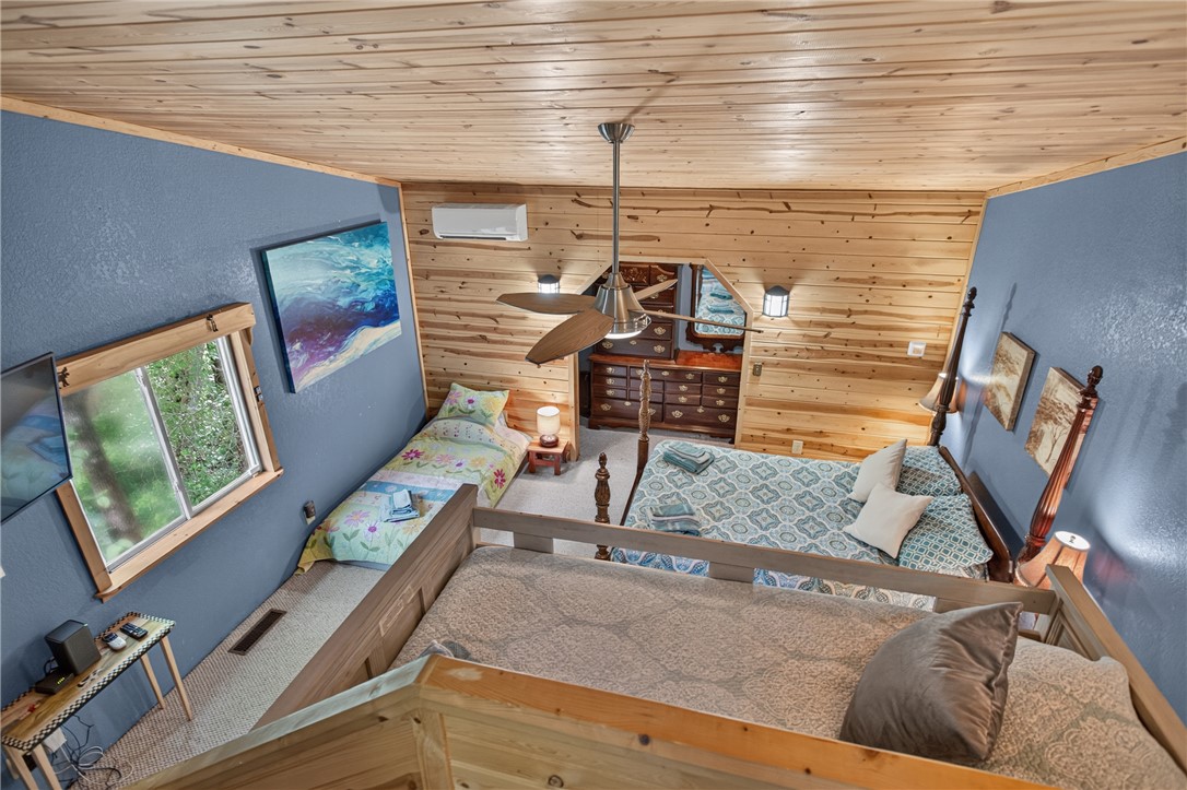 351 River Road Westminster, SC 29693 - Photo 32 of 50 A cozy bedroom loft showcases warm wood paneling and multiple sleeping areas, designed for comfort and relaxation.