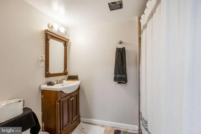a bathroom with a sink a toilet and mirror