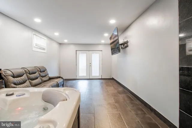 a hallway with a couch and a large window
