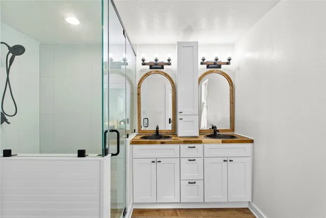 a bathroom with a double vanity sink and a mirror