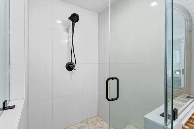 a bedroom with a bed a chandelier and a window