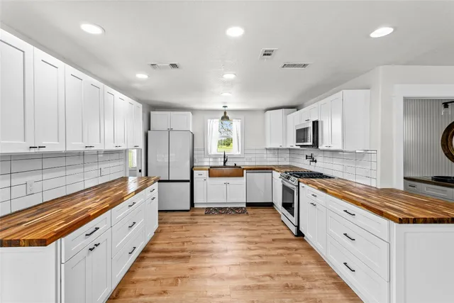 a large kitchen with stainless steel appliances lots of counter space sink and cabinets
