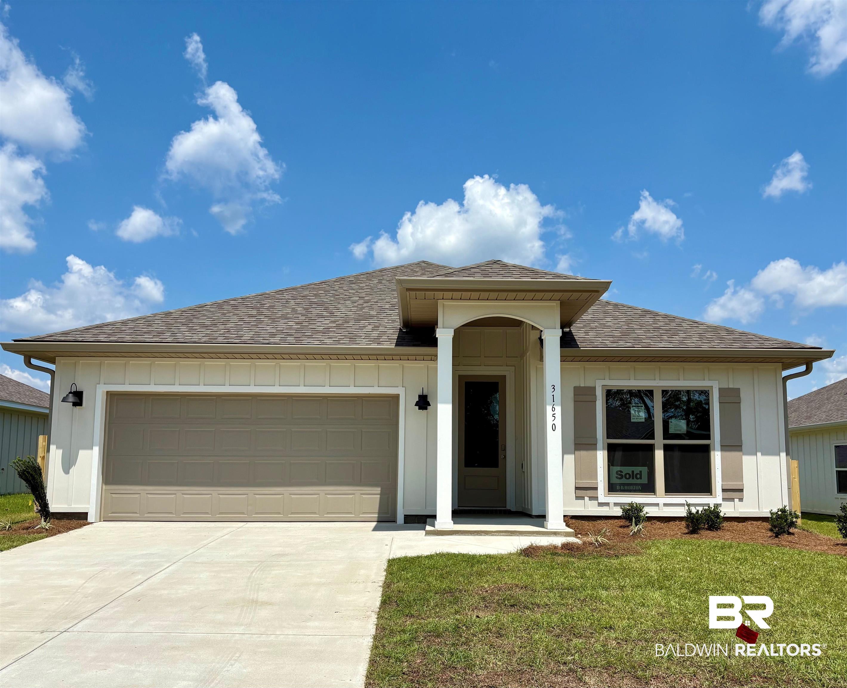 31650 Lyon Road Daphne, AL 36527 - Photo 1 of 31 Contemporary single-story residence with a covered entryway, a two-car garage, and a brown shingle roof