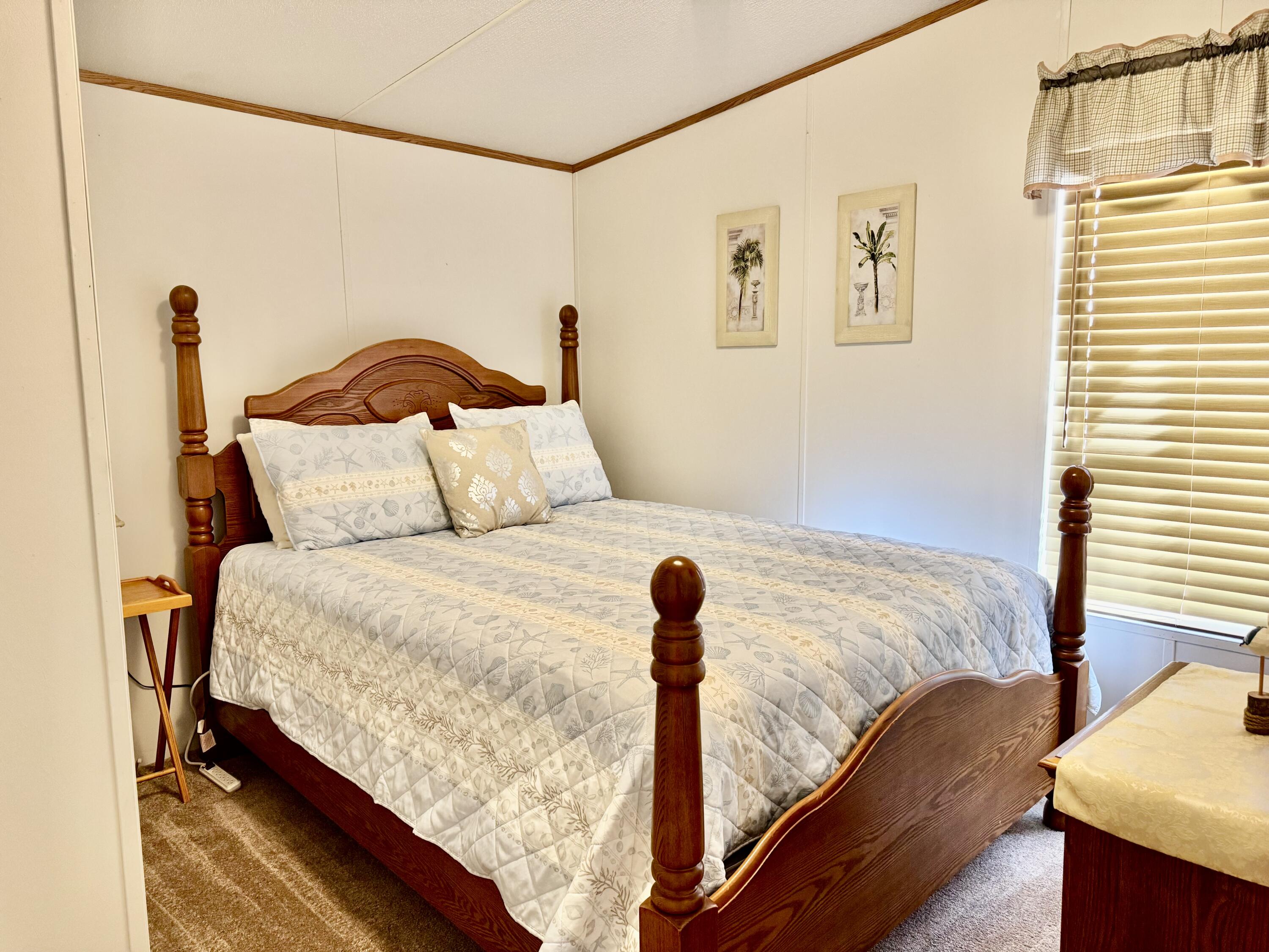 2305 Southeast 31st Street Okeechobee, FL 34974 - Photo 17 of 30 a bedroom with a bed and a window