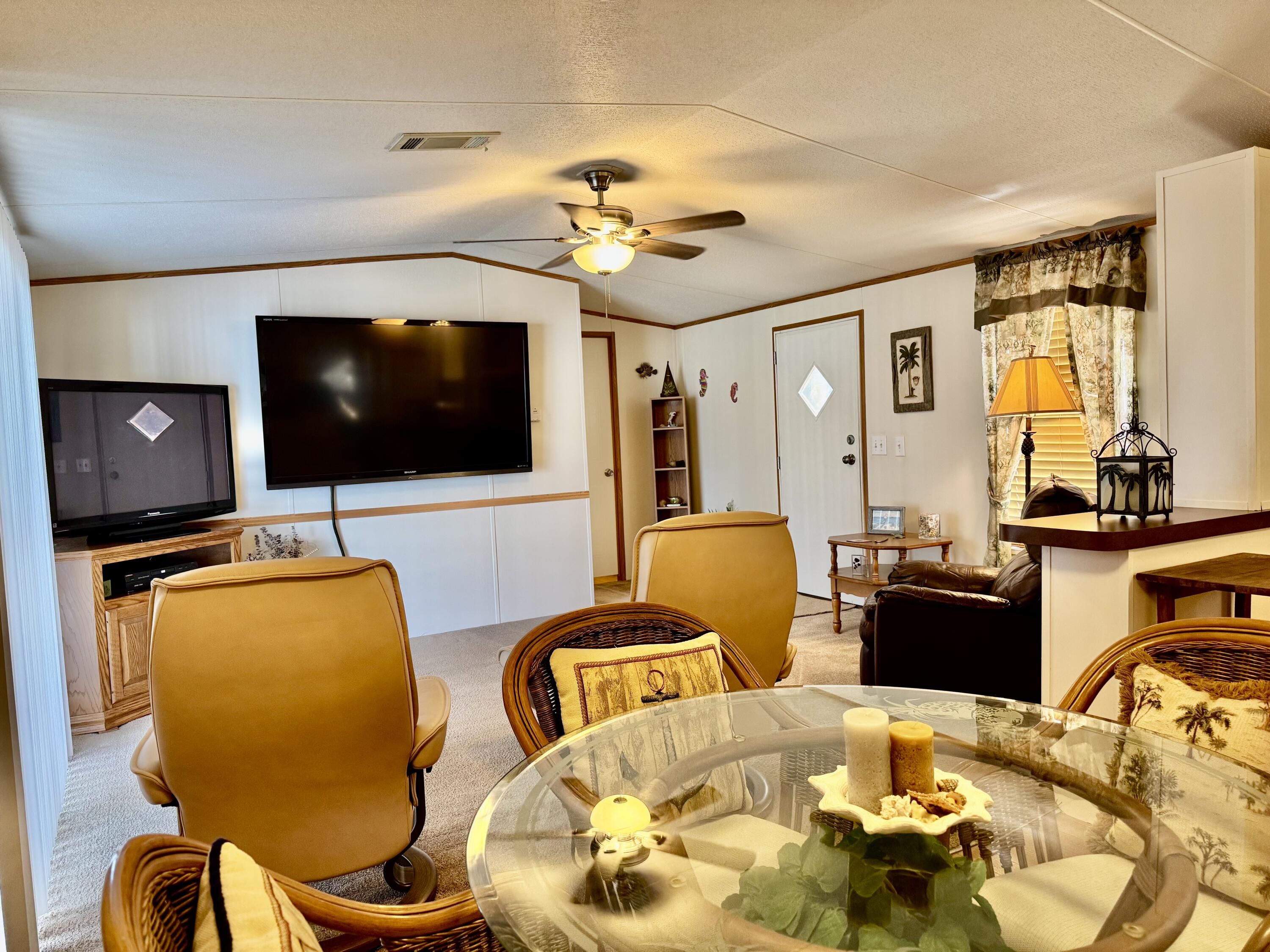 2305 Southeast 31st Street Okeechobee, FL 34974 - Photo 20 of 30 a living room with furniture and a flat screen tv