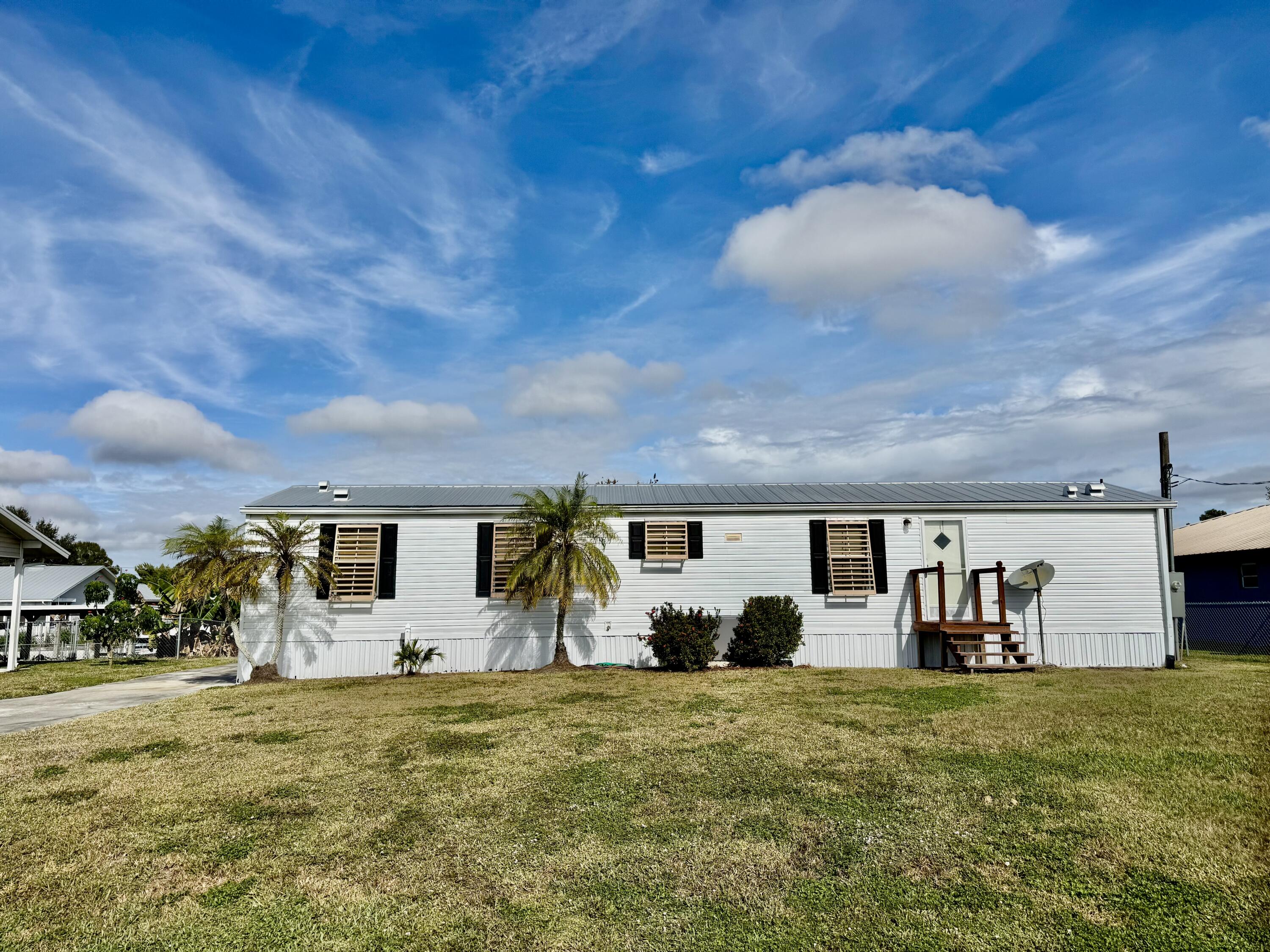 2305 Southeast 31st Street Okeechobee, FL 34974 - Photo 28 of 30 a front view of a house with garden