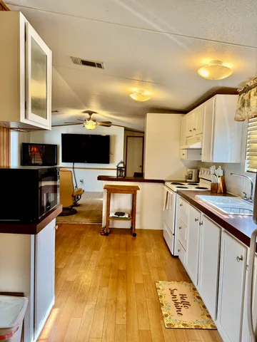 a kitchen with stainless steel appliances a stove a sink dishwasher and a microwave
