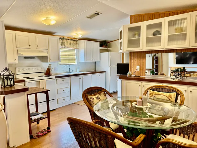 a kitchen with stainless steel appliances kitchen island granite countertop a stove a sink and a microwave