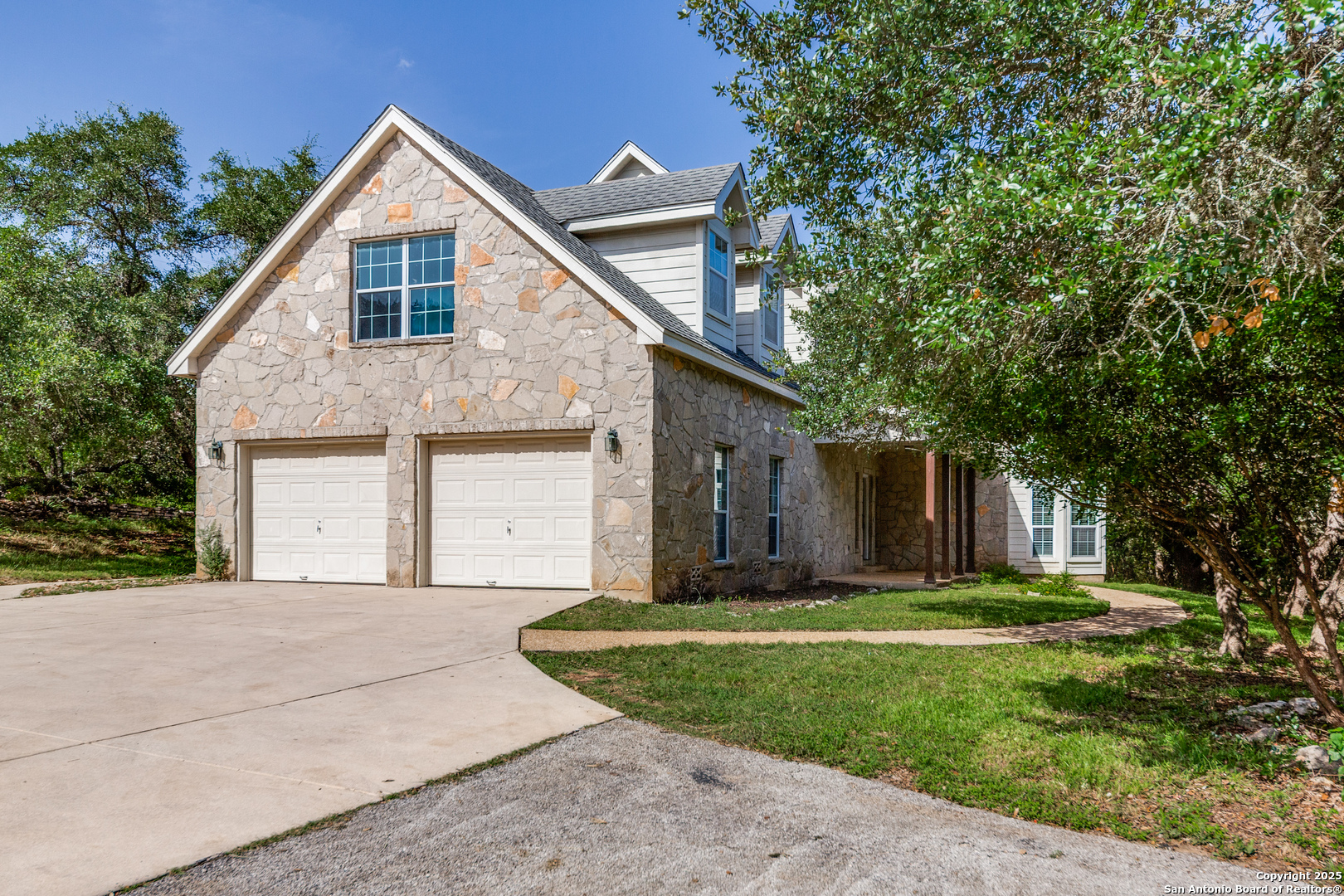 9109 Windwick Boerne, TX 78006 - Photo 1 of 35 a front view of a house with a yard and garage