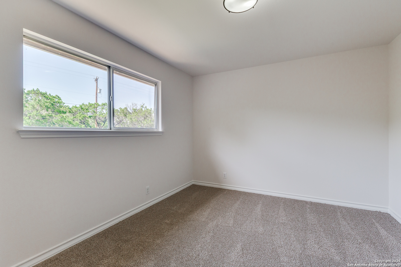 9109 Windwick Boerne, TX 78006 - Photo 22 of 35 an empty room with a window