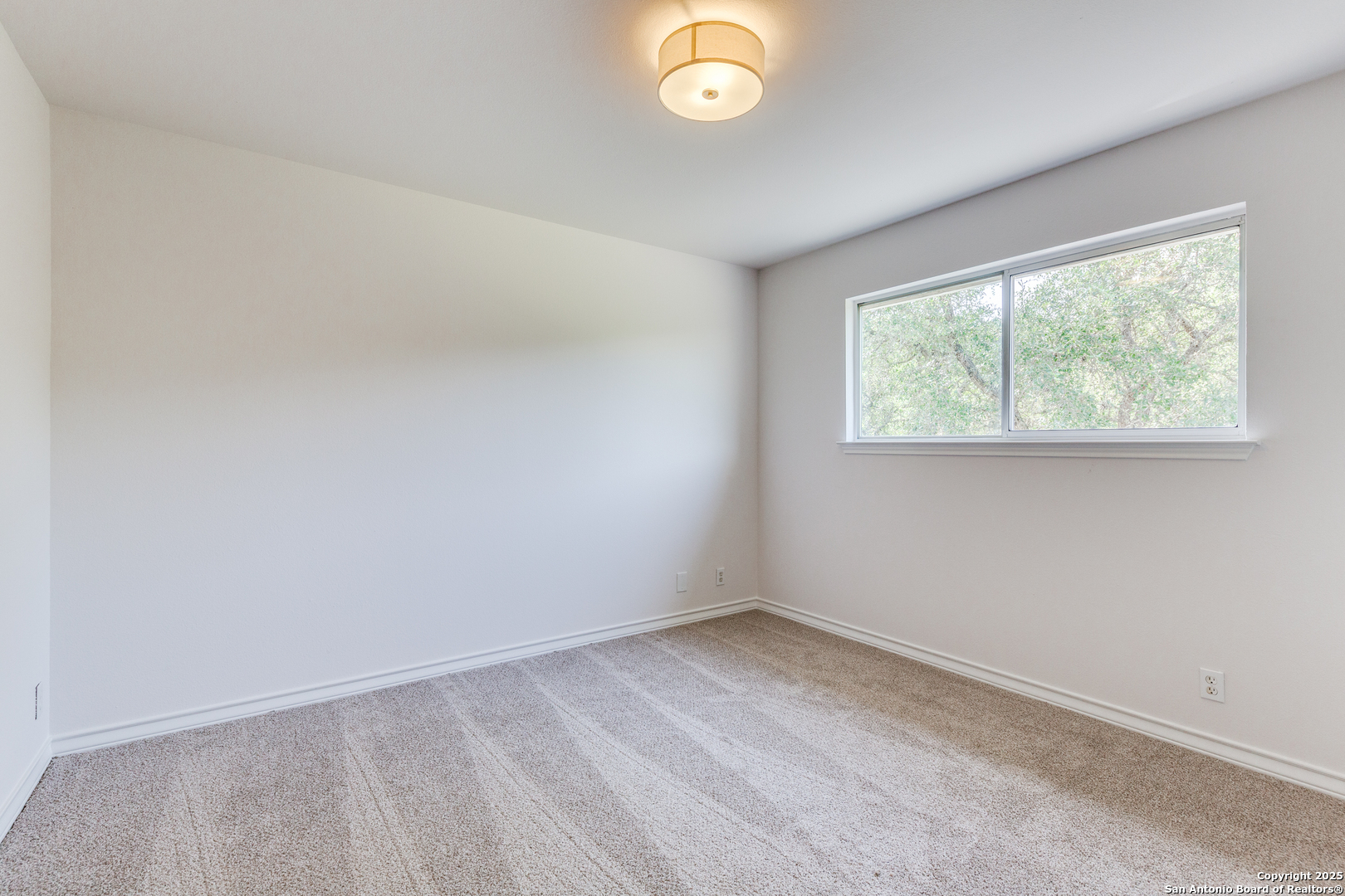 9109 Windwick Boerne, TX 78006 - Photo 24 of 35 an empty room with a window