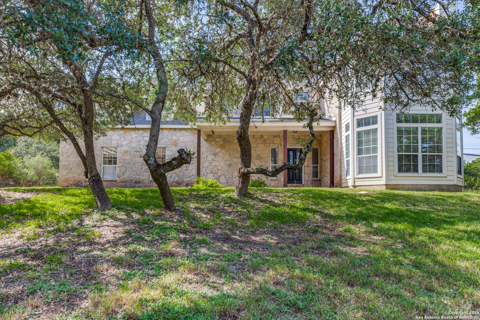 9109 Windwick Boerne, TX 78006 - Photo 5 of 35 a view of a backyard with a large tree