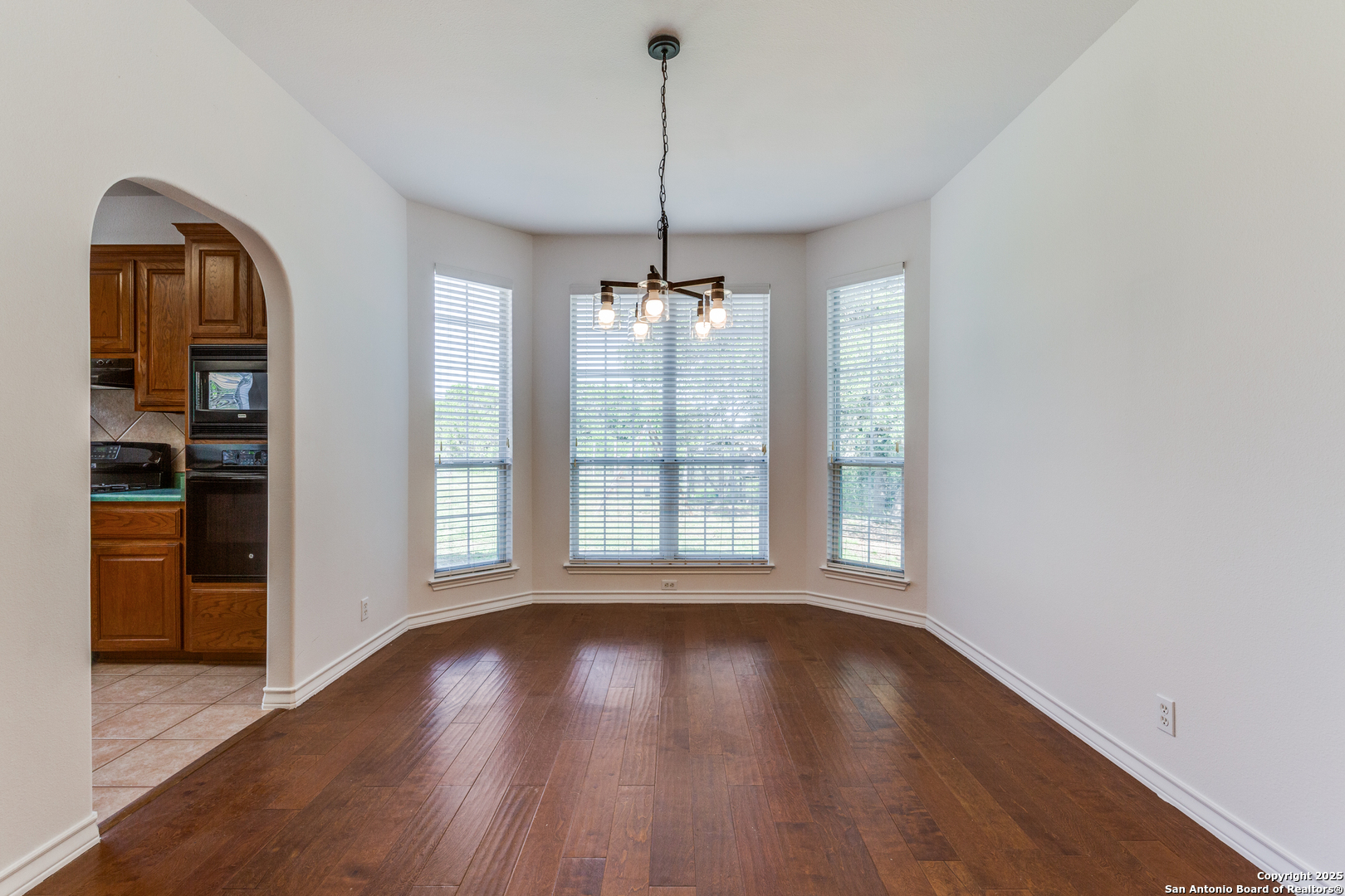 9109 Windwick Boerne, TX 78006 - Photo 10 of 35 a view of a room with wooden floor chandelier and windows