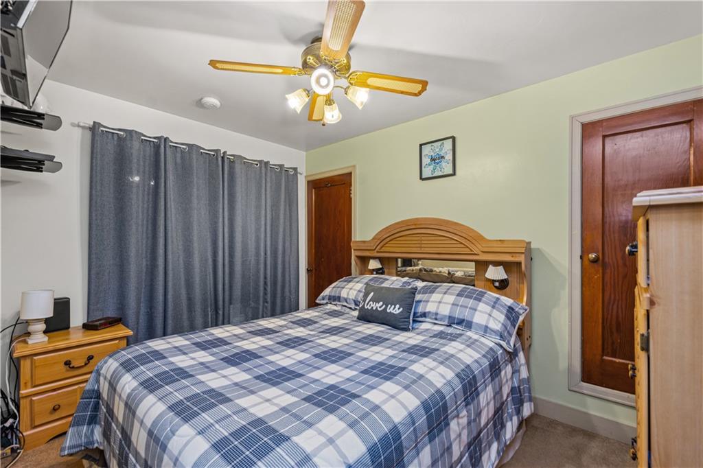 231 Rehoboth Church Road Perryopolis, PA 15473 - Photo 11 of 25 a bedroom with a bed and a chandelier