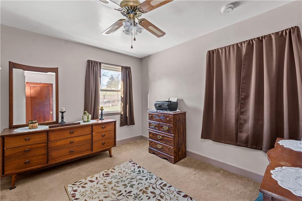 231 Rehoboth Church Road Perryopolis, PA 15473 - Photo 15 of 25 a room with a bed and a chandelier